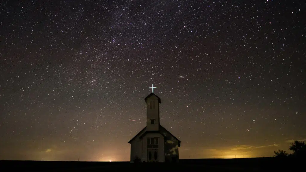 Church at night with bright cross