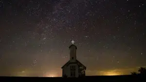 Church at night with bright cross